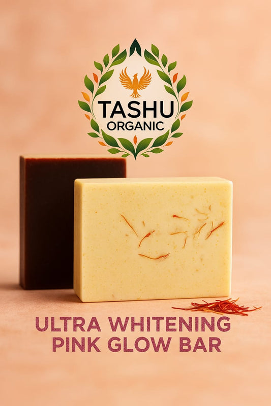 Two soap bars, one black and one yellow, with TASHU Organic logo above on a peach background.